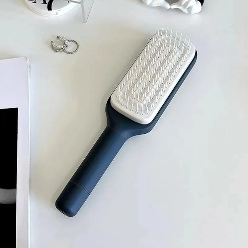 Dark grey hair brush on a white surface